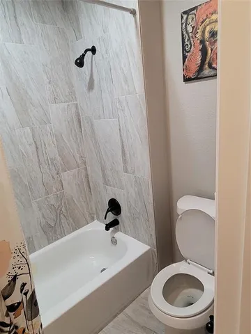 a white toilet sitting next to a bathroom sink