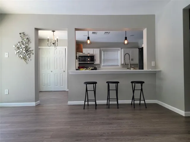 a view of kitchen with furniture and wooden floor