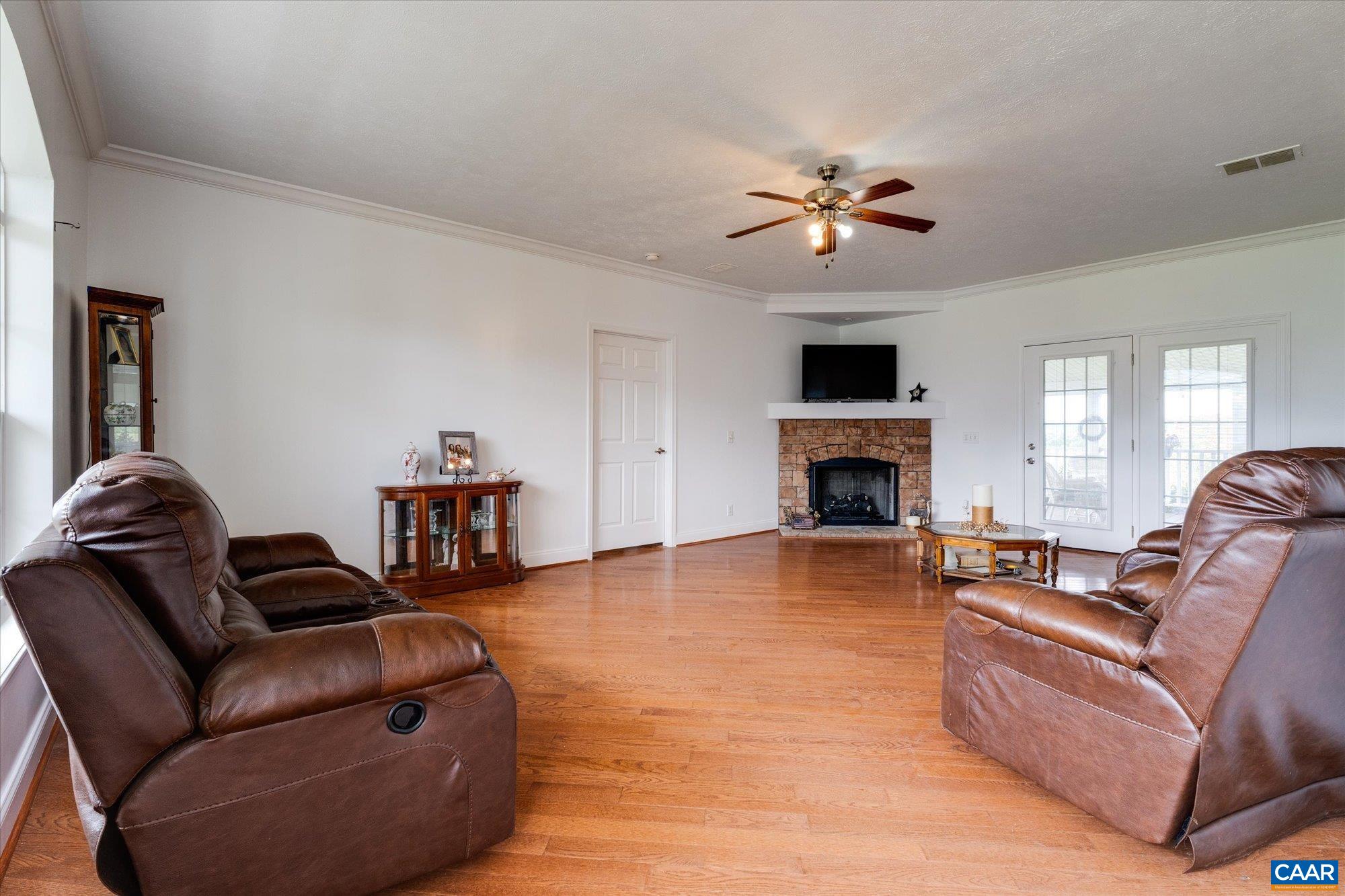 3225 Lynn Hollow Road North Tazewell, VA 24630 - Photo 26 of 62 a living room with furniture a fireplace and a flat screen tv