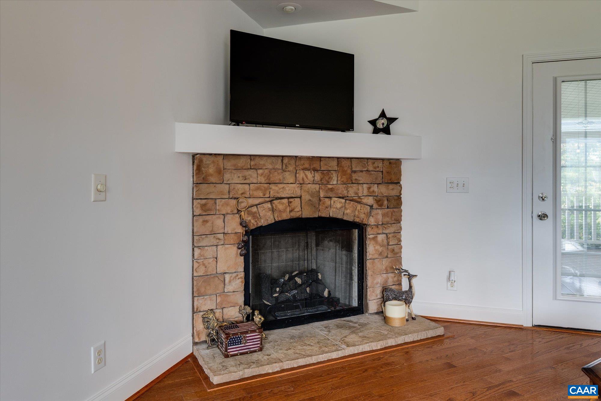 3225 Lynn Hollow Road North Tazewell, VA 24630 - Photo 27 of 62 a living room with a fireplace and a flat screen tv