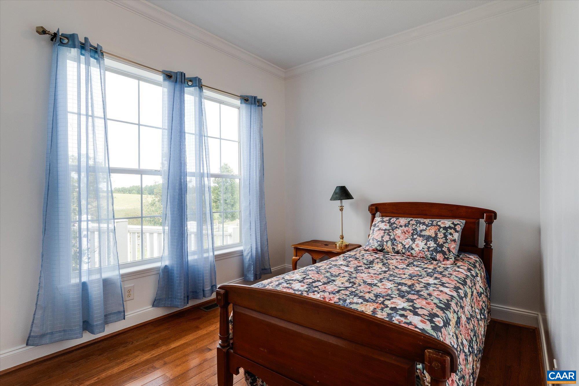 3225 Lynn Hollow Road North Tazewell, VA 24630 - Photo 34 of 62 a bedroom with a large bed and wooden floor
