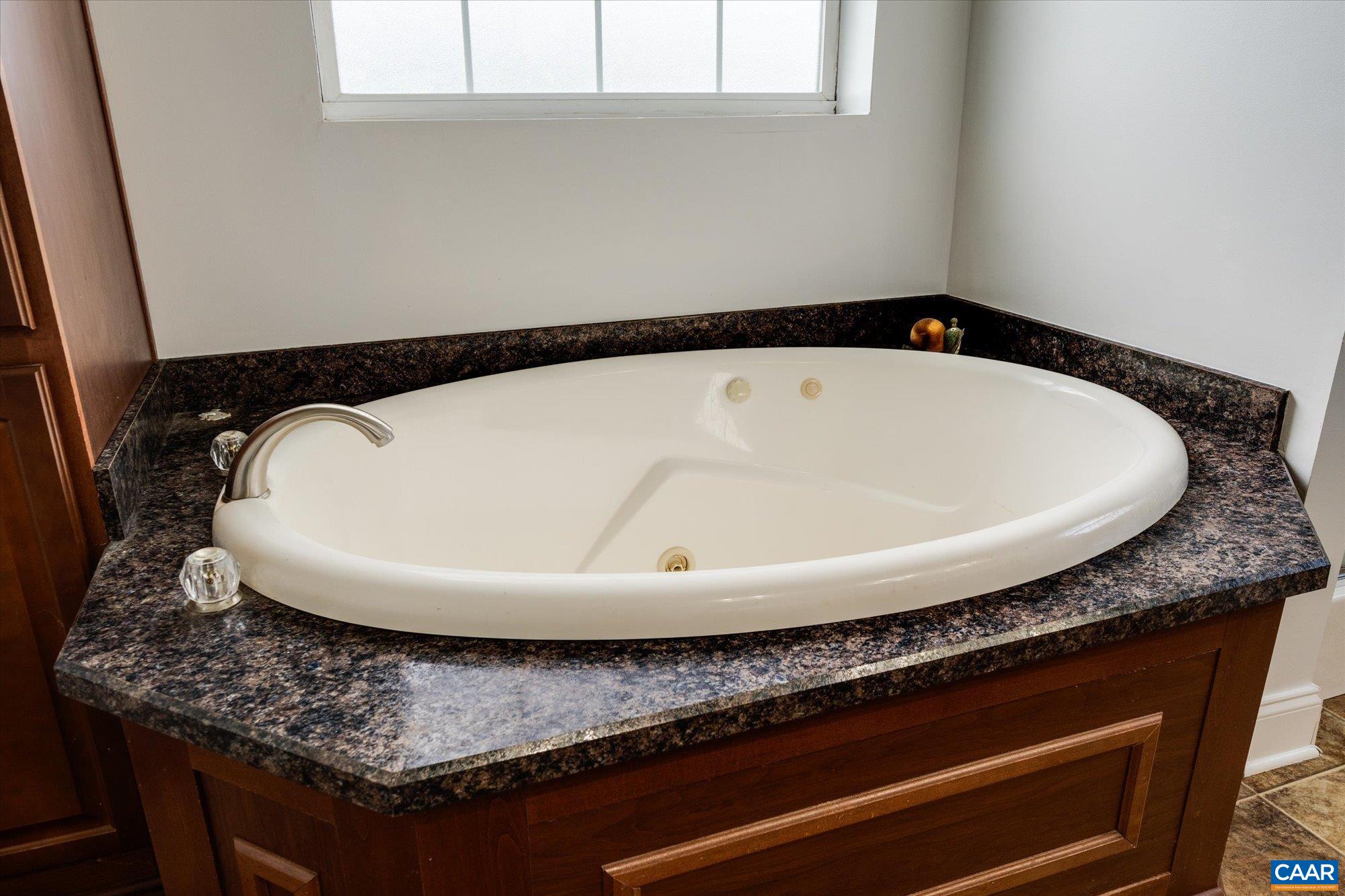 3225 Lynn Hollow Road North Tazewell, VA 24630 - Photo 42 of 62 a bathroom with a granite countertop sink and mirror
