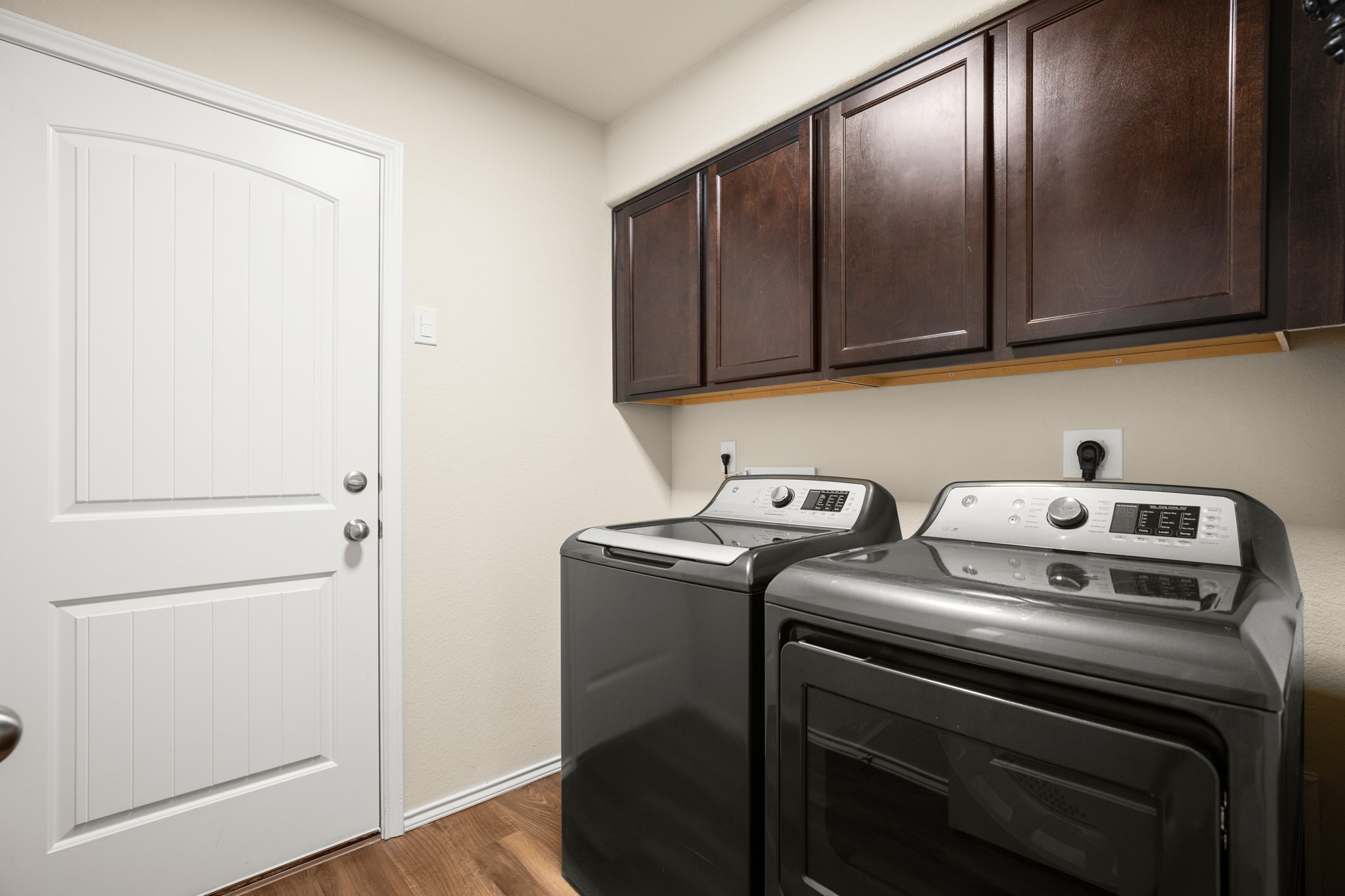 5526 Perdita Drive Belton, TX 76513 - Photo 16 of 26 Laundry room with dark wood-style flooring, cabinet space, and separate washer and dryer