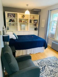 a living room with a bed furniture and decor