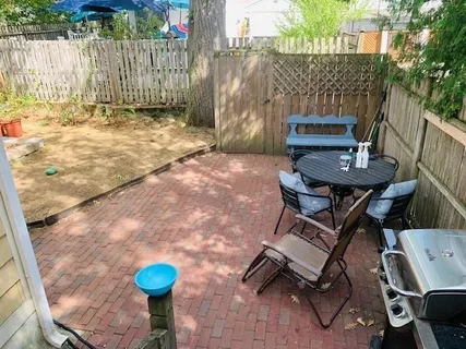 a backyard of a house with table and chairs