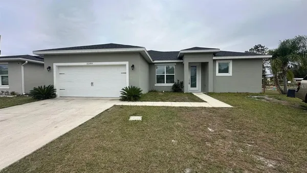 a view of a house with a yard and garage
