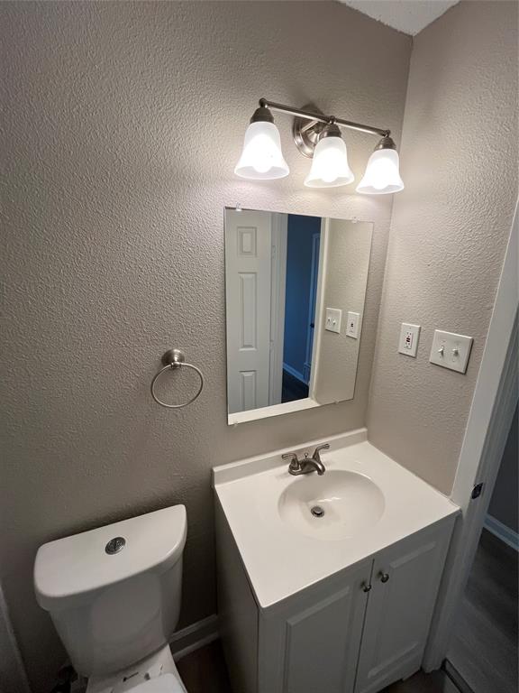 1125 Rancho Drive Mesquite, TX 75149 - Photo 11 of 23 Bathroom featuring a textured wall and vanity