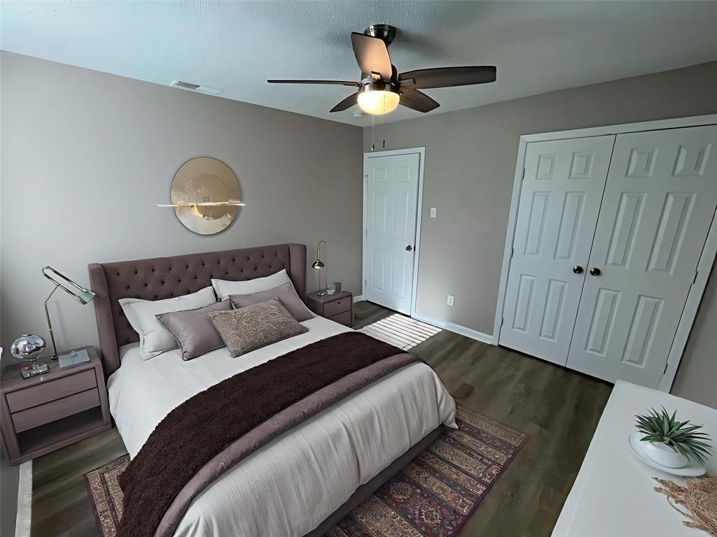 1125 Rancho Drive Mesquite, TX 75149 - Photo 14 of 23 Bedroom featuring dark wood-style flooring, a ceiling fan, and a closet