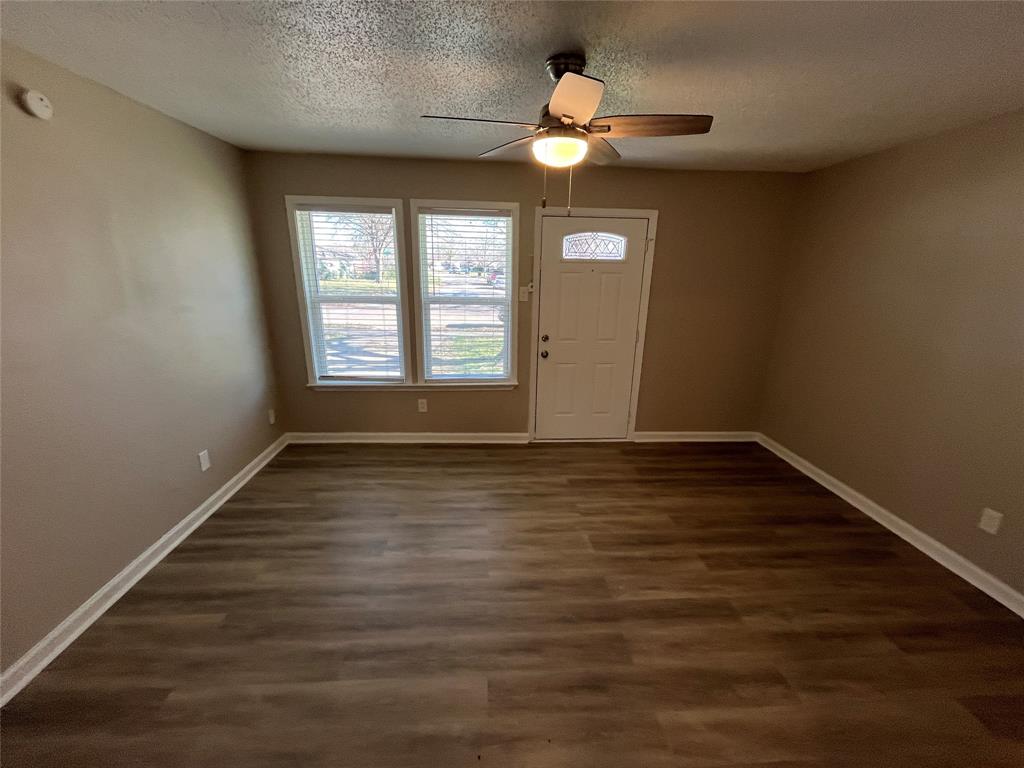 1125 Rancho Drive Mesquite, TX 75149 - Photo 5 of 23 Foyer with dark wood-style flooring, a textured ceiling, and ceiling fan