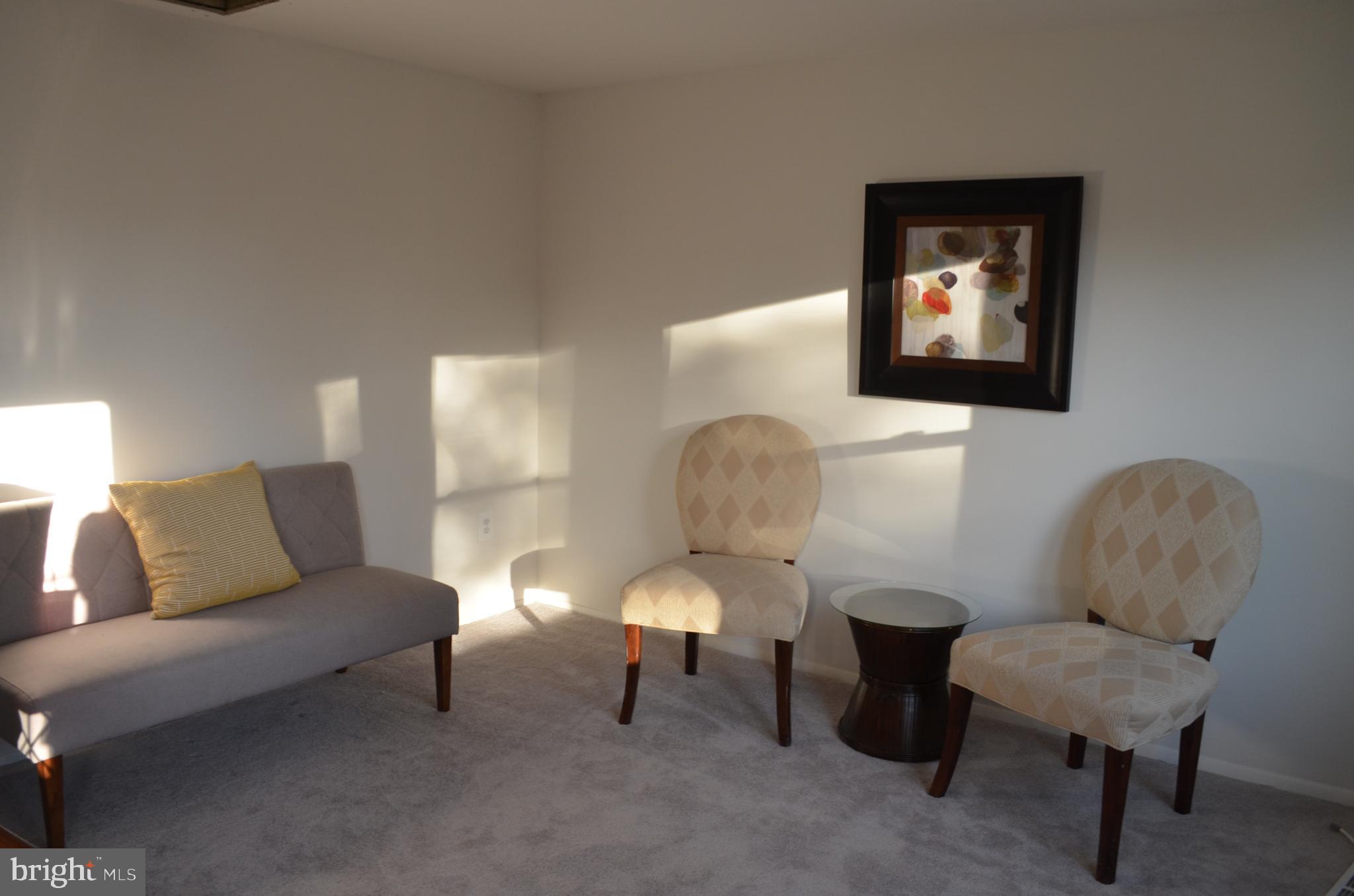 1739 Northridge Lane Frederick, MD 21702 - Photo 2 of 45 a living room with furniture and a lamp