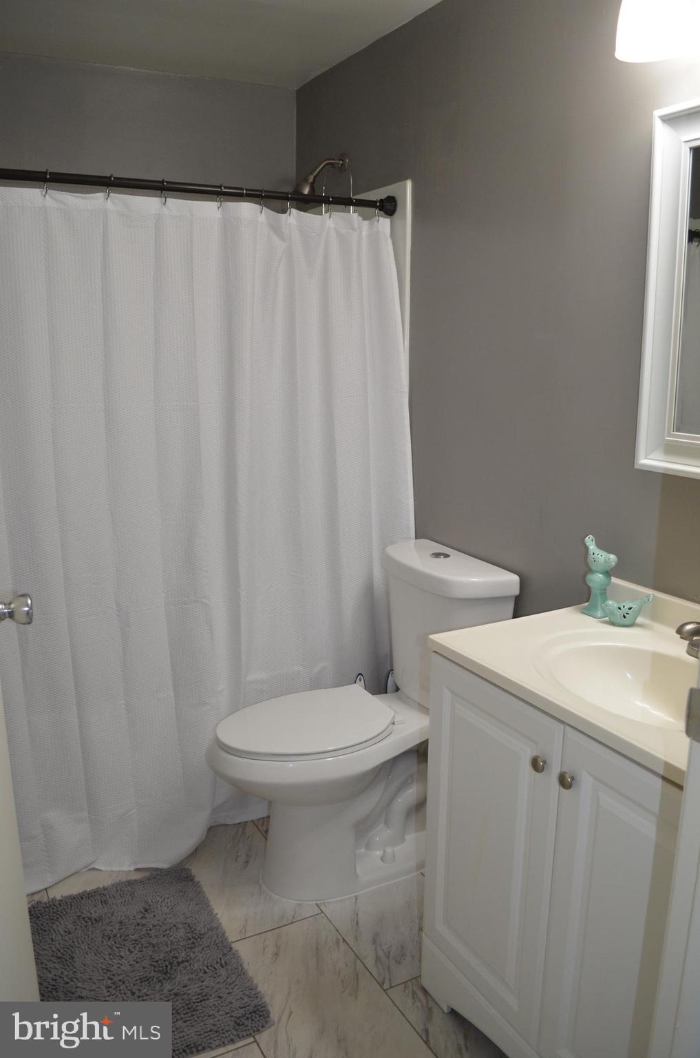 1739 Northridge Lane Frederick, MD 21702 - Photo 23 of 45 a white toilet sitting next to a white sink and vanity