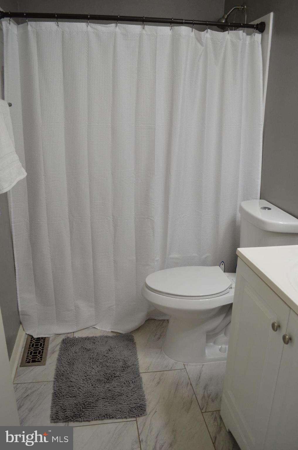 1739 Northridge Lane Frederick, MD 21702 - Photo 26 of 45 a white toilet sitting next to a shower curtain