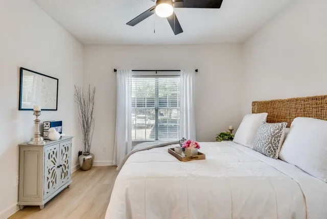 a bedroom with a bed and a window