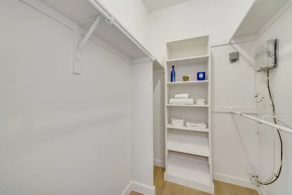 a view of walk in closet with empty racks