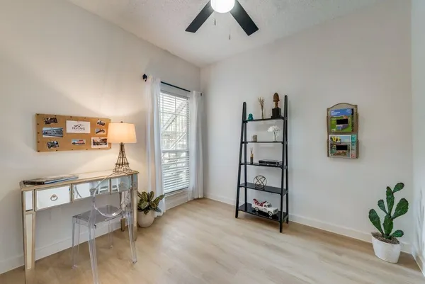 a view of a bedroom with furniture and window
