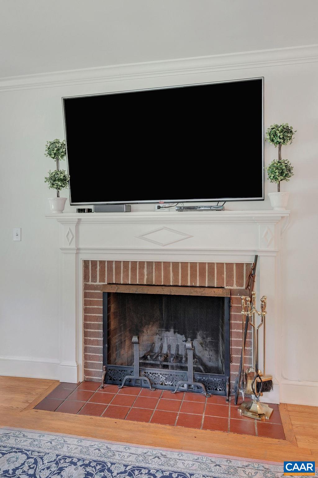 1500 Rugby Avenue Charlottesville, VA 22903 - Photo 16 of 50 a living room with a fireplace and a flat screen tv
