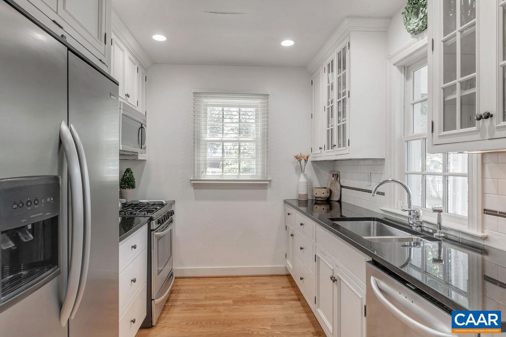 1500 Rugby Avenue Charlottesville, VA 22903 - Photo 19 of 50 a kitchen with stainless steel appliances granite countertop a sink stove and refrigerator