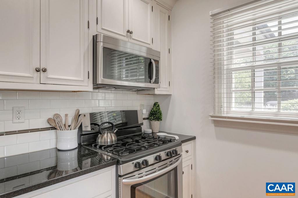 1500 Rugby Avenue Charlottesville, VA 22903 - Photo 20 of 50 a kitchen with granite countertop white cabinets and a stove