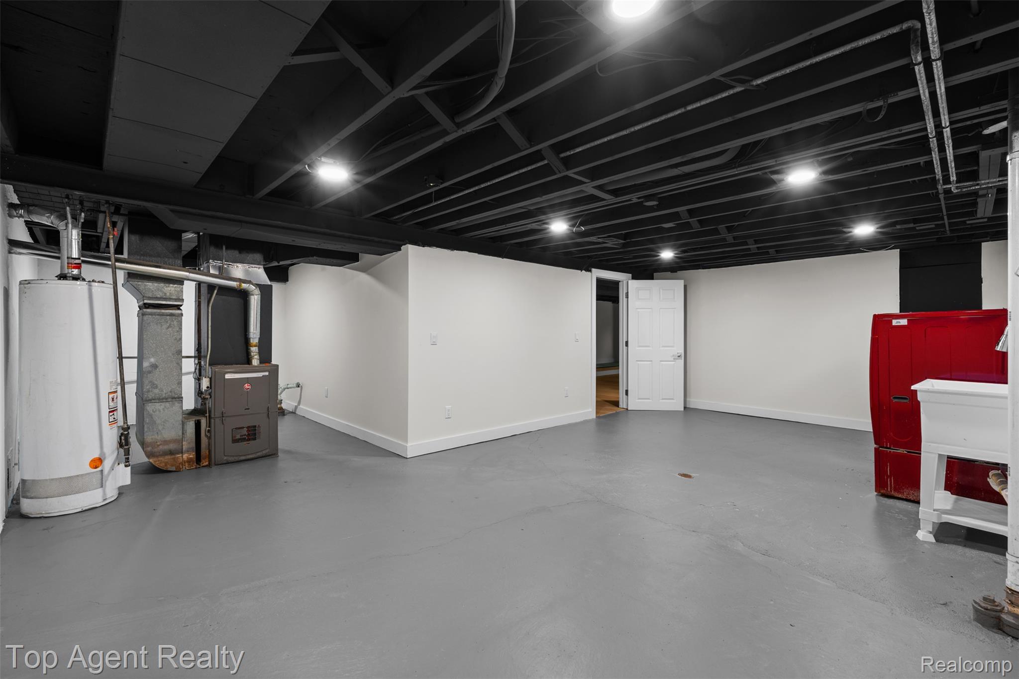 29863 Fall River Road Southfield, MI 48076 - Photo 33 of 50 Spacious basement area featuring a painted concrete floor, bright white walls, and a black painted exposed ceiling with recessed lighting