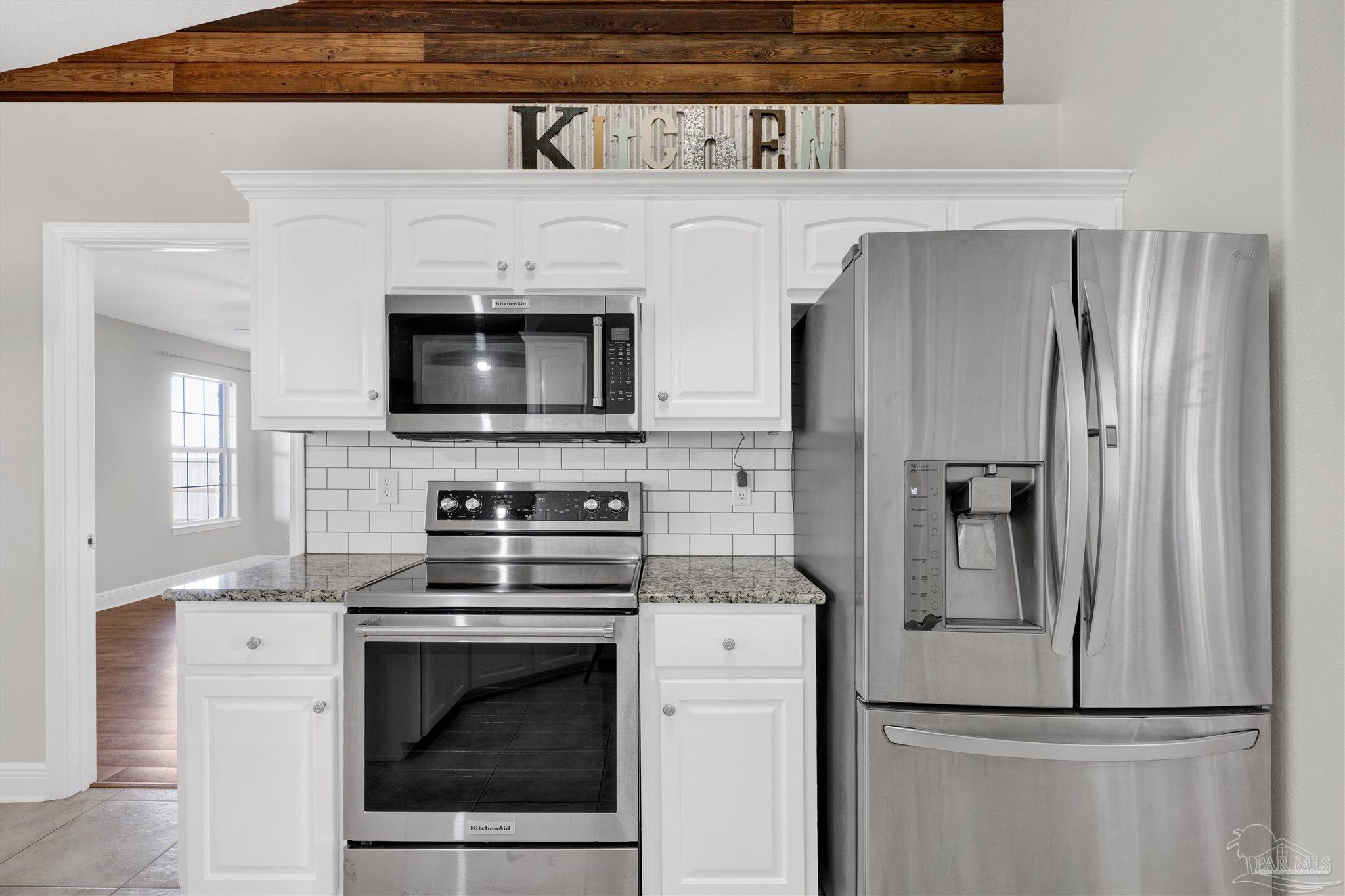 3351 North Simmons Road Jay, FL 32565 - Photo 12 of 36 a kitchen with stainless steel appliances a refrigerator stove and microwave