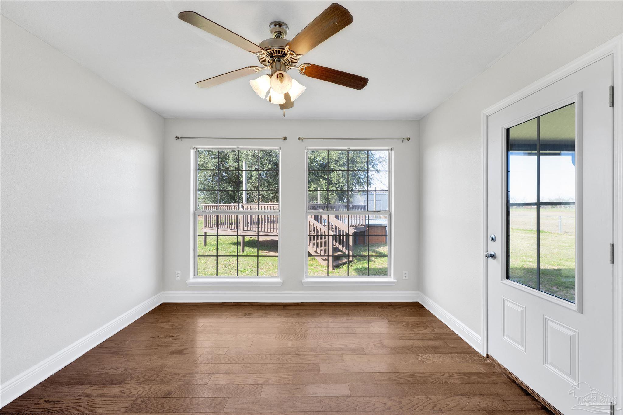3351 North Simmons Road Jay, FL 32565 - Photo 15 of 36 wooden floor in an empty room with a window