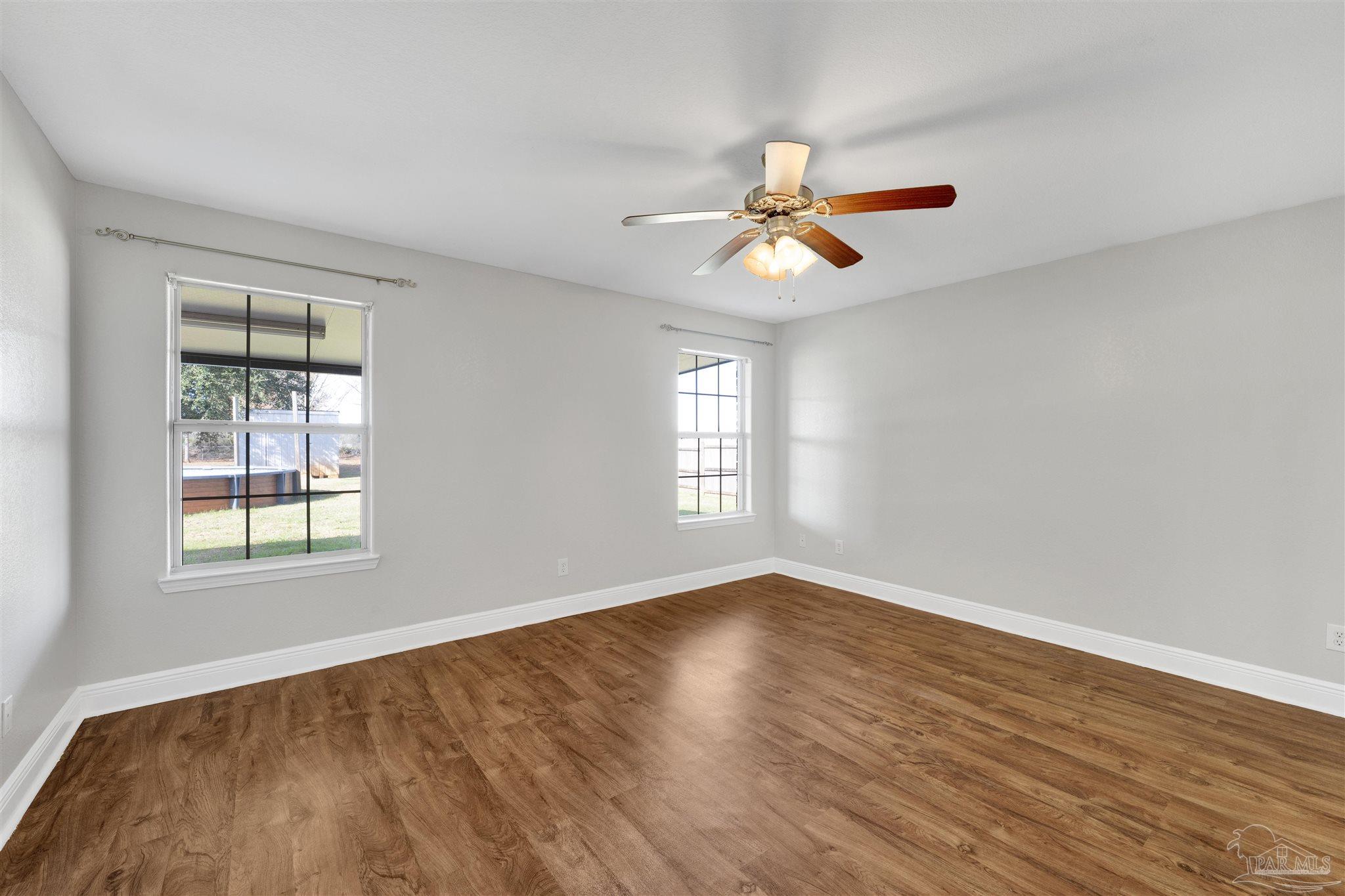 3351 North Simmons Road Jay, FL 32565 - Photo 17 of 36 wooden floor in an empty room with a window
