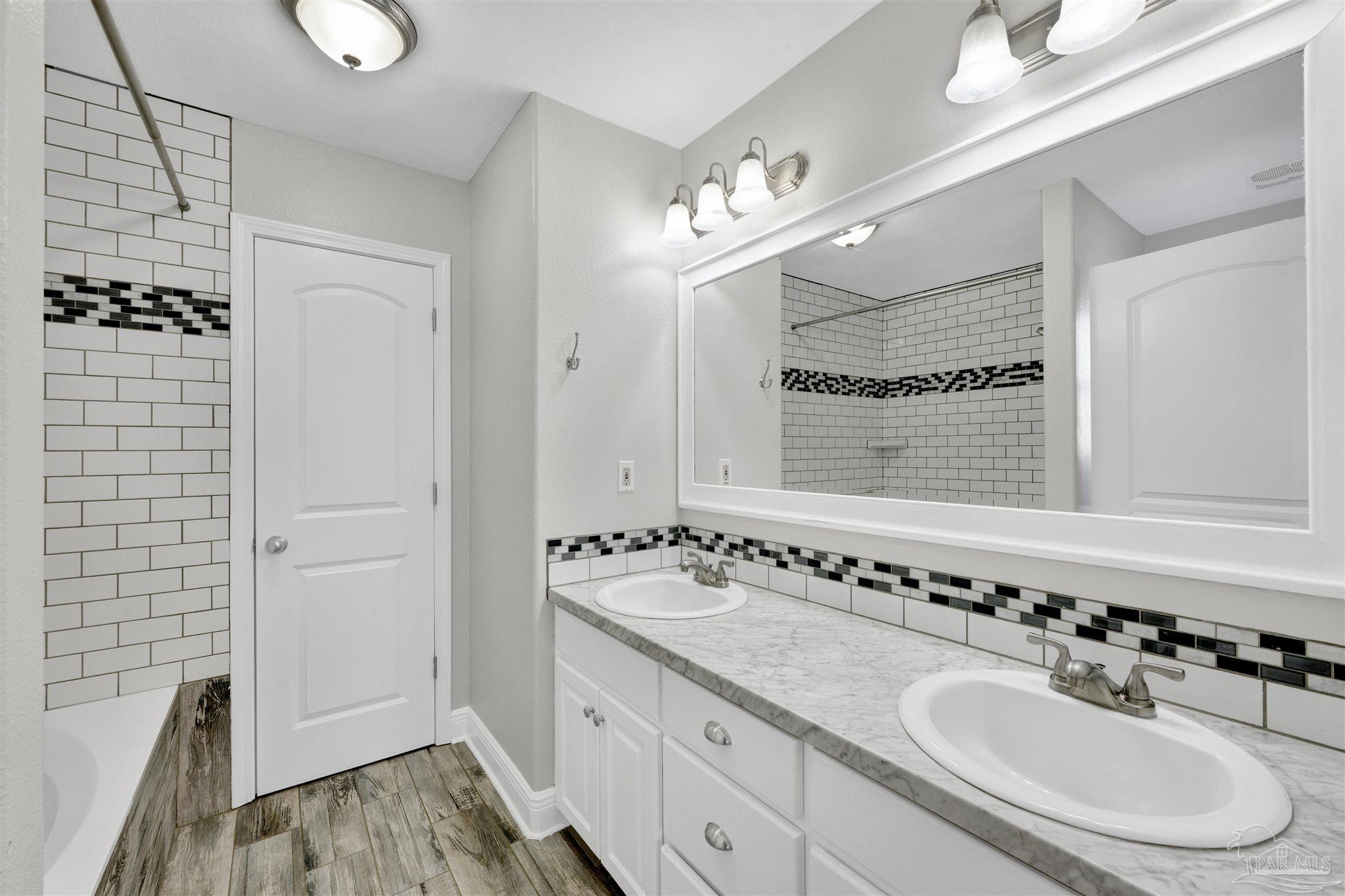 3351 North Simmons Road Jay, FL 32565 - Photo 19 of 36 a bathroom with a sink double vanity and a mirror