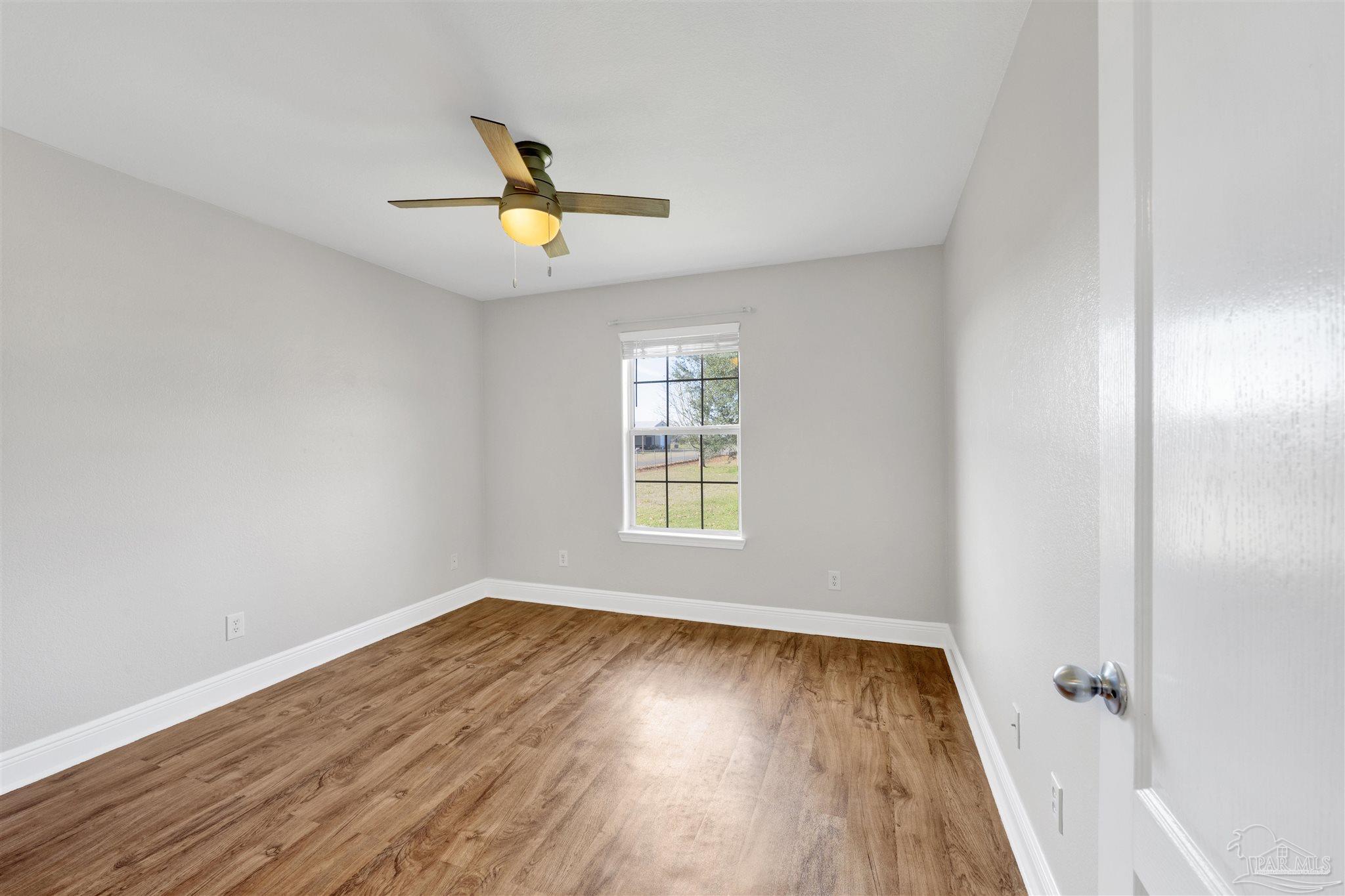 3351 North Simmons Road Jay, FL 32565 - Photo 22 of 36 wooden floor in an empty room with a window
