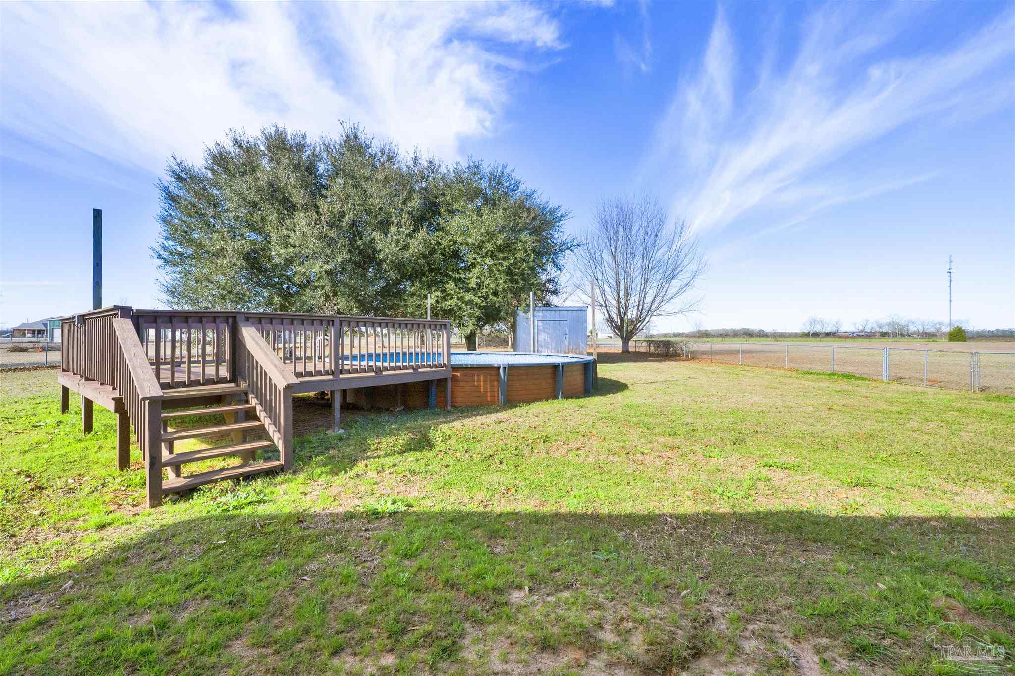 3351 North Simmons Road Jay, FL 32565 - Photo 26 of 36 a view of swimming pool with chairs and garden