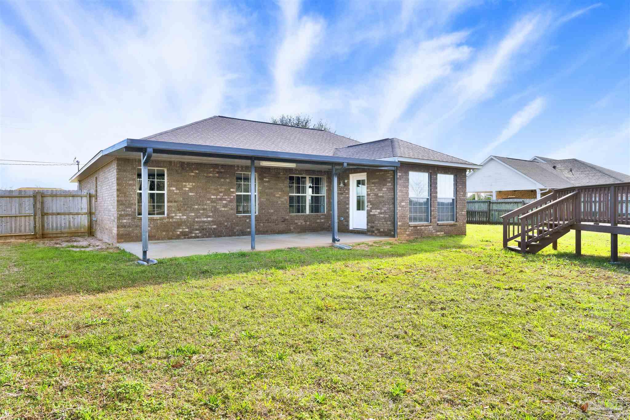 3351 North Simmons Road Jay, FL 32565 - Photo 28 of 36 a front view of a house with a garden
