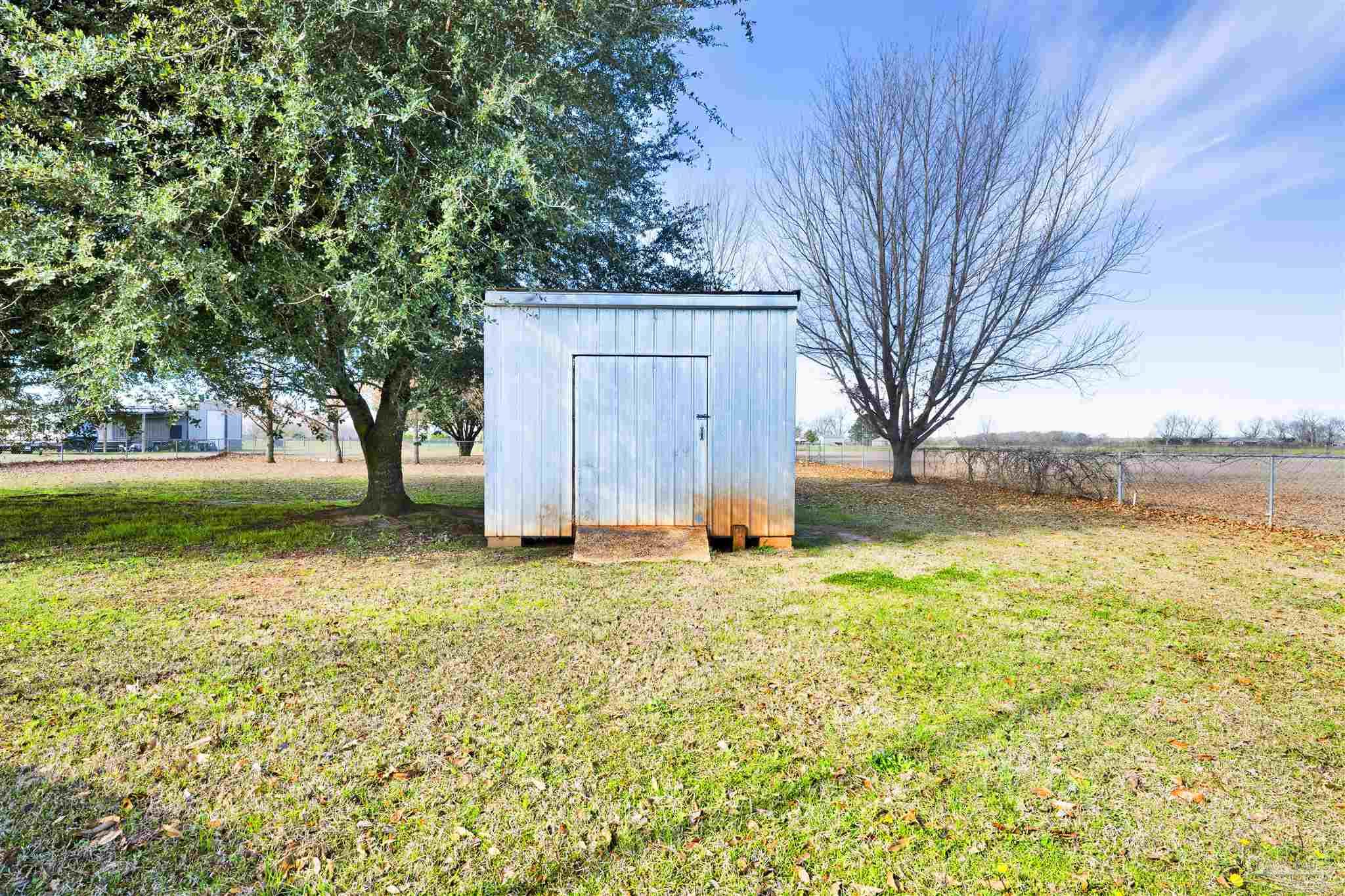 3351 North Simmons Road Jay, FL 32565 - Photo 29 of 36 a house with trees in front of it
