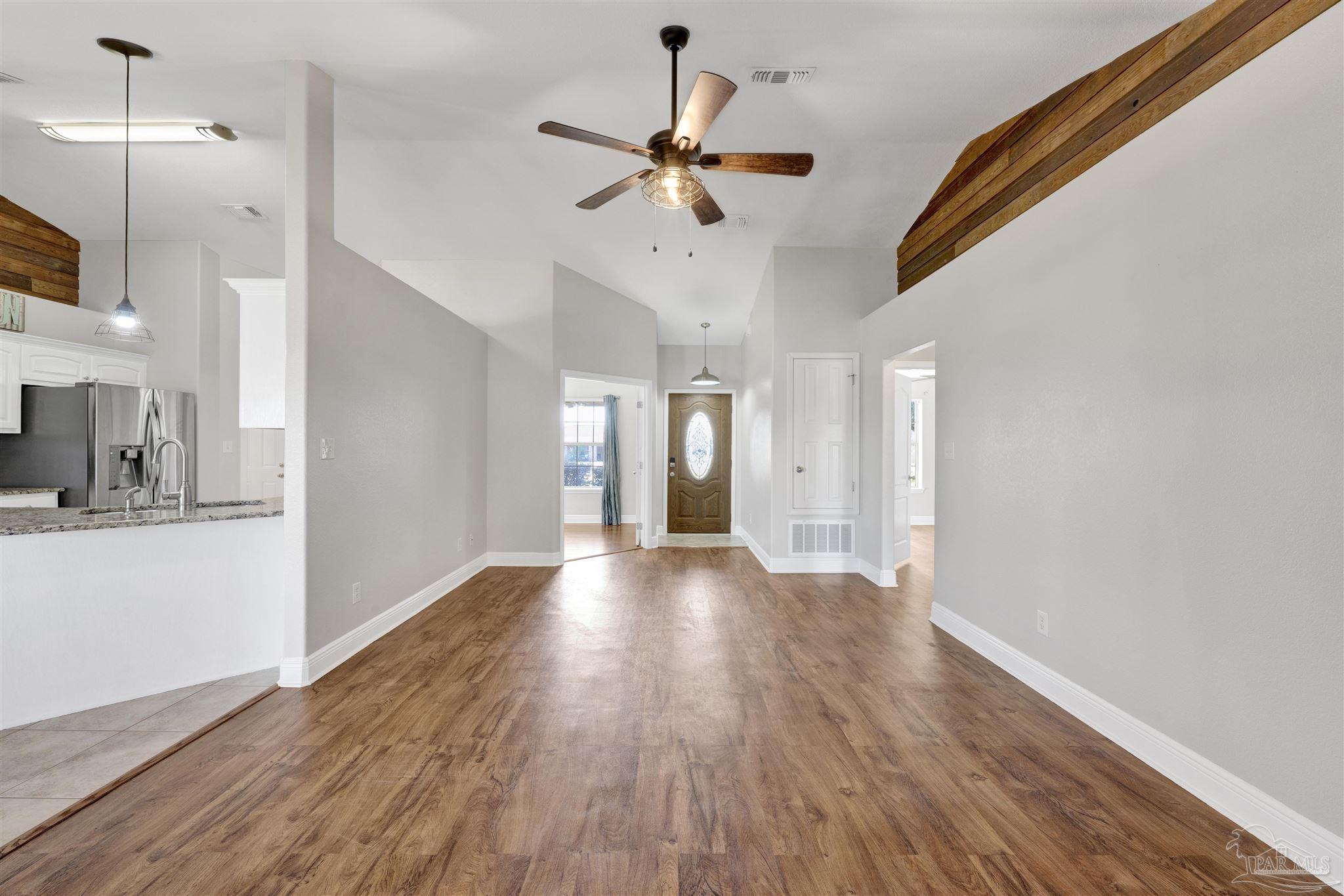 3351 North Simmons Road Jay, FL 32565 - Photo 8 of 36 a view of an empty room with window and wooden floor