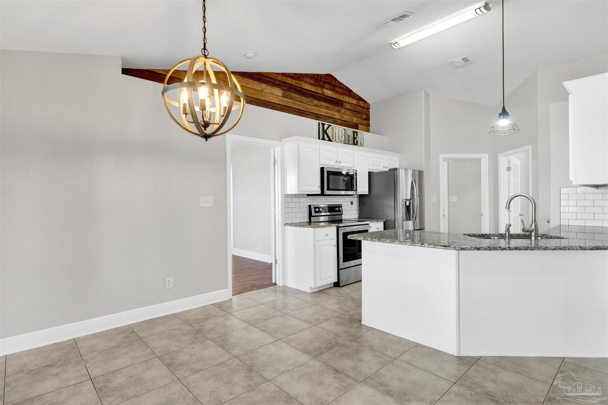 3351 North Simmons Road Jay, FL 32565 - Photo 10 of 36 a kitchen with cabinets and stainless steel appliances