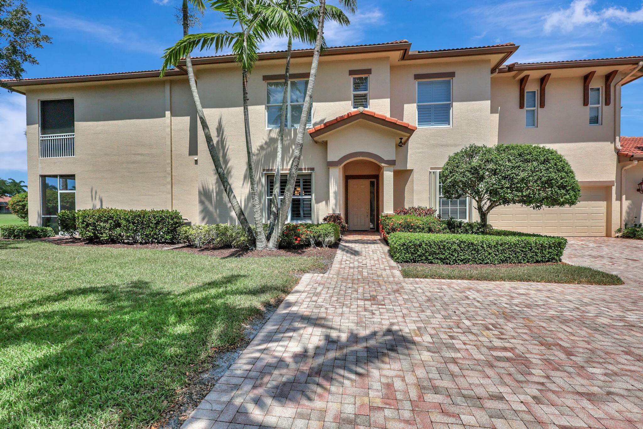 10307 Orchid Reserve Drive West Palm Beach, FL 33412 - Photo 1 of 19 a front view of a house with garden