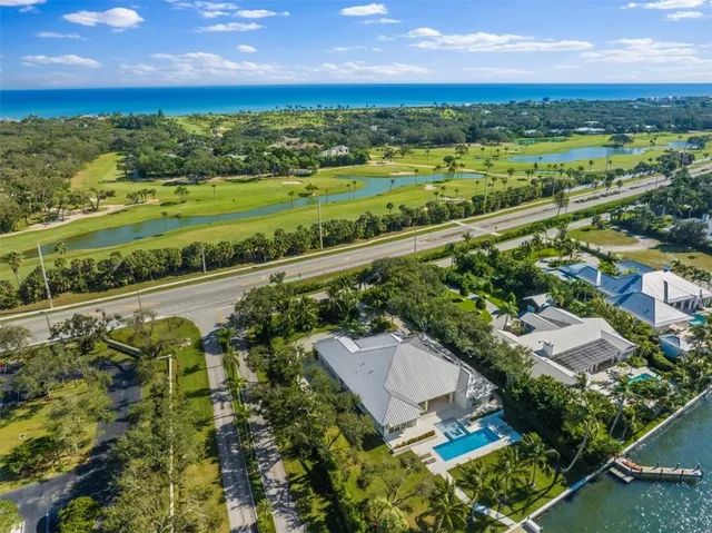 an aerial view of a residential houses with outdoor space and street view