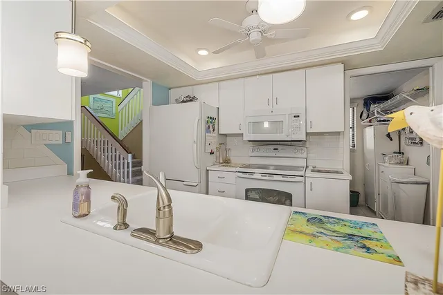 a kitchen with kitchen island a stove a sink dishwasher and a refrigerator with wooden floor