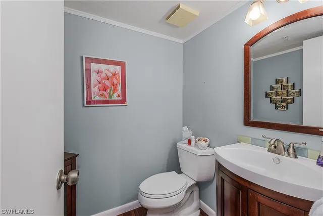 a bathroom with a granite countertop sink mirror vanity and toilet