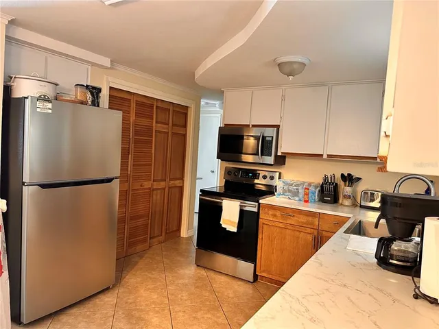 a kitchen with stainless steel appliances a refrigerator stove microwave and sink