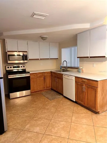 a kitchen with stainless steel appliances granite countertop a sink and cabinets