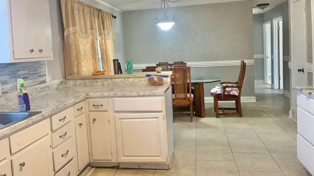a utility room with cabinets washer and dryer