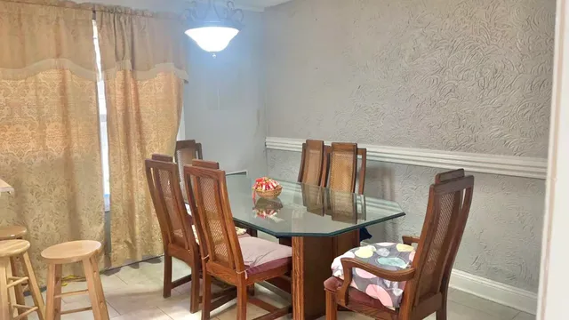 a view of a dining room with furniture and wooden floor