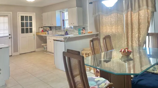 a dining room with furniture and a chandelier