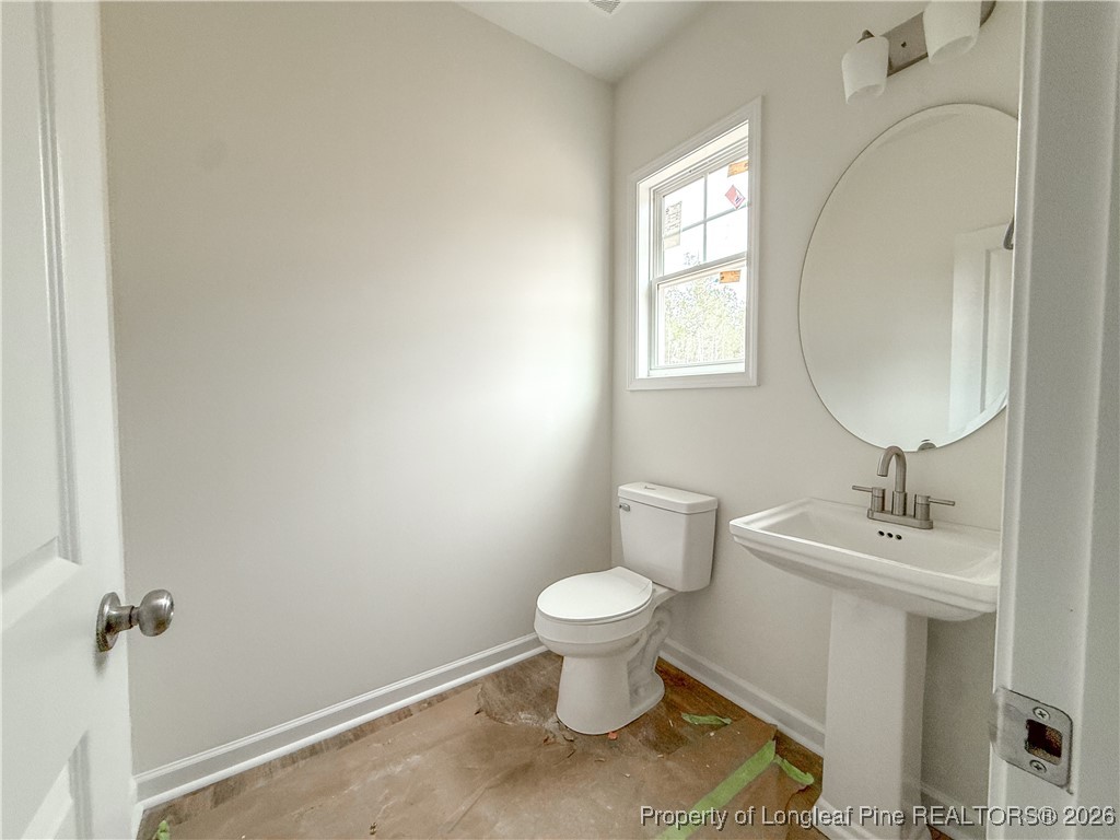 1128 Alex Baker (lot 3) Road Raeford, NC 28376 - Photo 14 of 25 a bathroom with a toilet sink and mirror