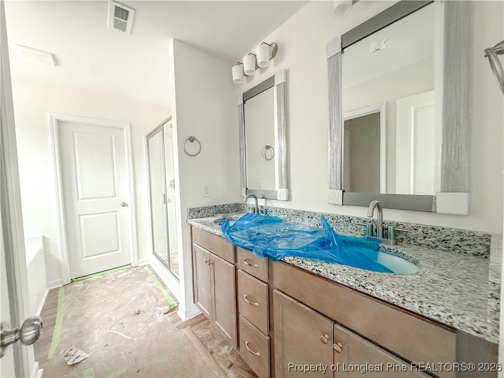 1128 Alex Baker (lot 3) Road Raeford, NC 28376 - Photo 18 of 25 a bathroom with a granite countertop sink and a mirror