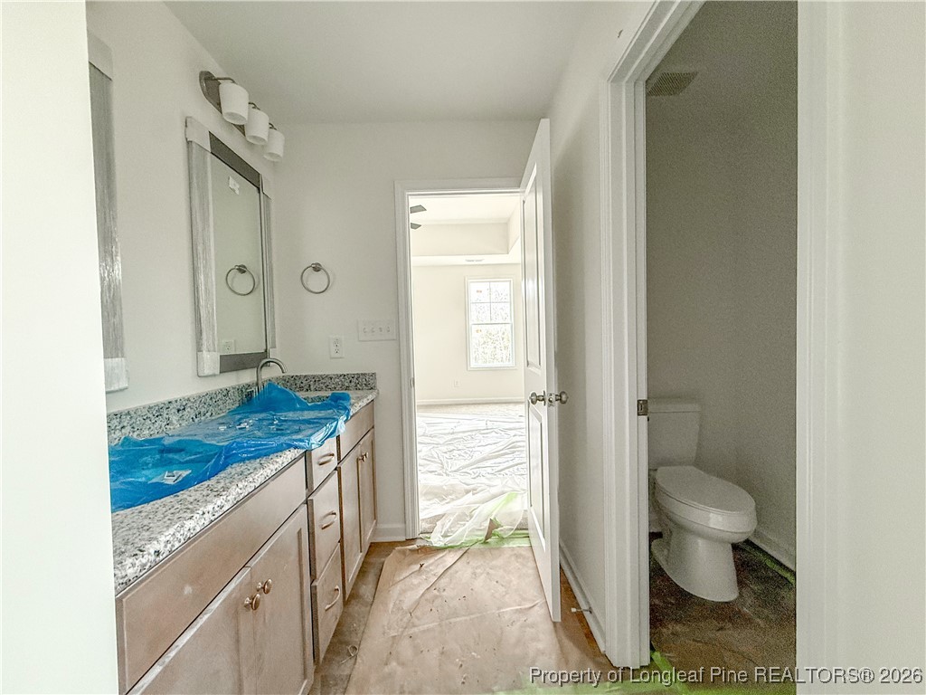 1128 Alex Baker (lot 3) Road Raeford, NC 28376 - Photo 20 of 25 a bathroom with a granite countertop sink toilet and shower
