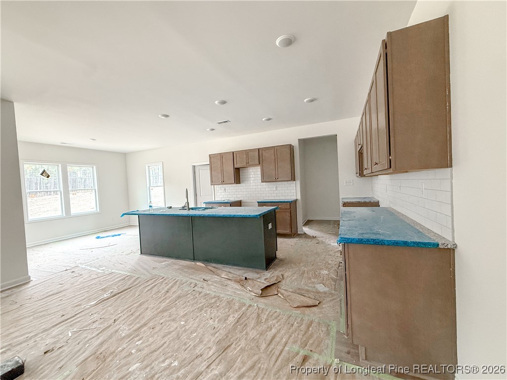 1128 Alex Baker (lot 3) Road Raeford, NC 28376 - Photo 6 of 25 a kitchen with stainless steel appliances kitchen island granite countertop a sink and cabinets