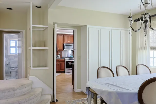 a spacious bedroom with a bed and a dresser