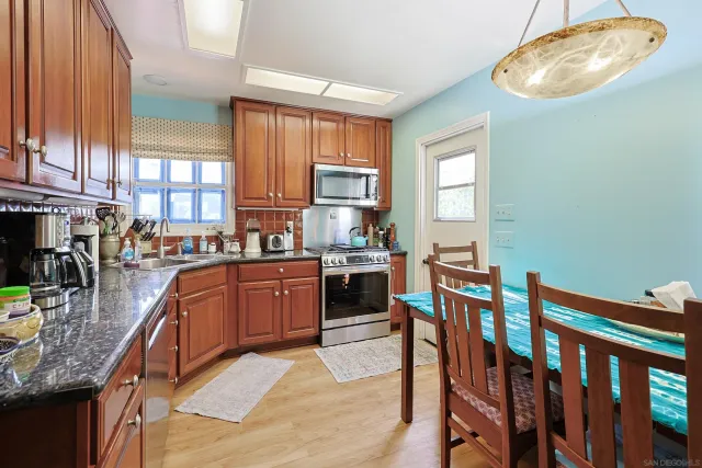 a kitchen with stainless steel appliances granite countertop a stove a sink dishwasher and cabinets