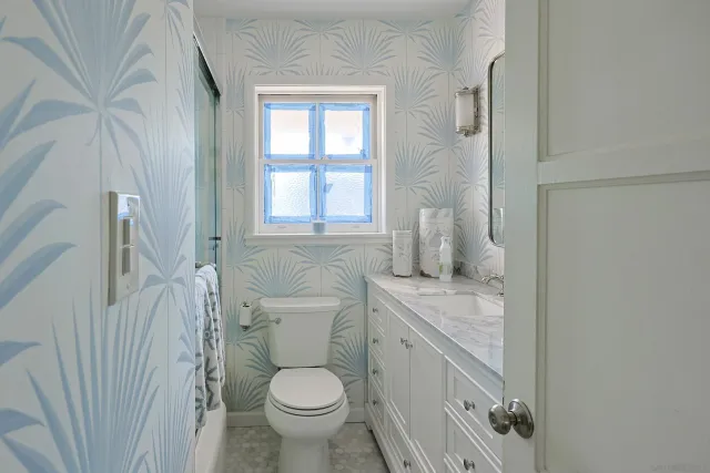 a bathroom with a sink toilet and window