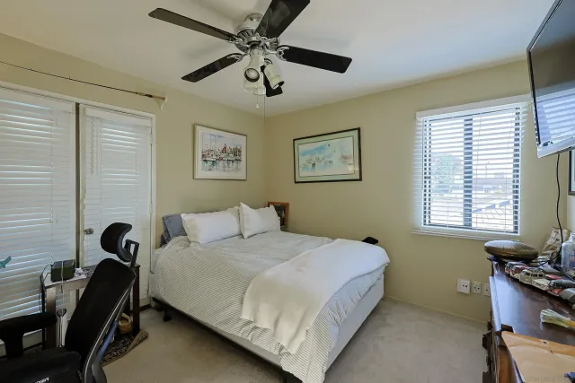 a bedroom with a bed and a desk